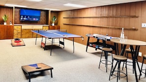 Game On! Our game room features air hockey, ping pong, and cornhole boards for outdoor fun. Plus, enjoy a mini fridge and a 75-inch smart TV for endless entertainment options.  Game room is in the lower level of the house and also opens to the stream.  