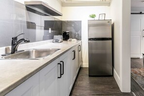 Functional Kitchen Space Featuring A Large Fridge And Ample Countertops