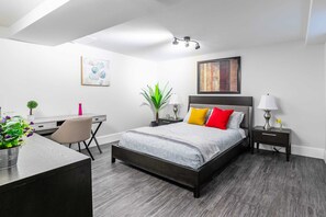 Bright Bedroom With A Queen Bed And Functional Workspace