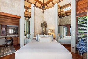A sumptuous king-size bed centres the first bedroom adorned in Balinese-inspired design. There's a workspace where you can focus on some work or study. 
