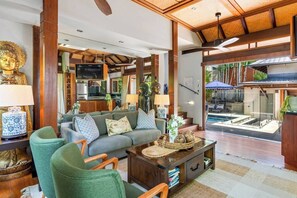 The living area opens out to the pool, providing a seamless transition to the outdoors.