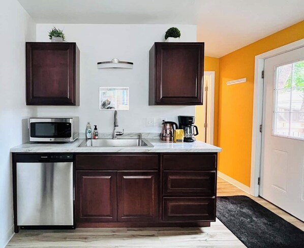 A spacious and adequately stocked kitchen with all the essential tools needed for prepping simple meals - stainless pots & pans etc., plus coffee, tea, and a selection of pantry items. 