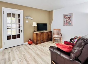 A smart TV with streaming apps sits atop a hutch housing a few games if you prefer interactive pleasures.