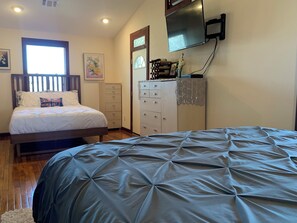 Bedroom 1 features 2 beds: 1 King and 1 Queen. Private deck and bathroom.
