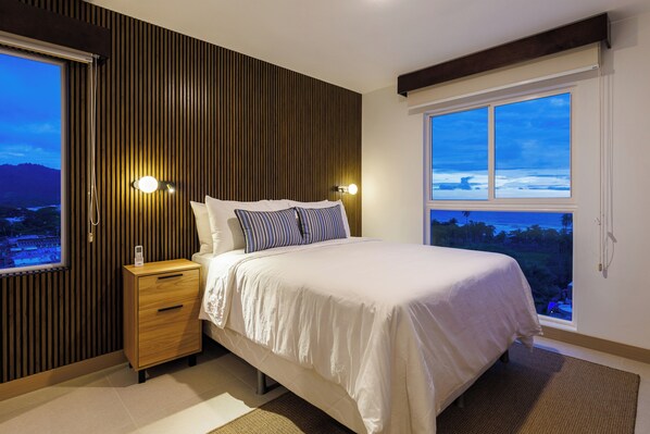 Comfy master bed with views of the ocean.