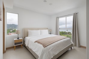 Master bedroom with king-sized bed and ocean views from the 13th floor