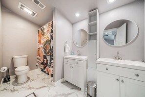 Large bathroom with tub and two separate sinks 