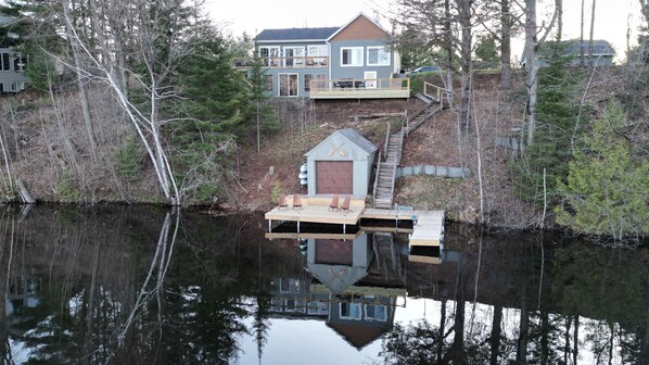Nestled in nature, this charming lakeside cabin boasts a spacious deck with stunning views! Perfect for a peaceful retreat, it offers easy lake access and cozy outdoor seating.