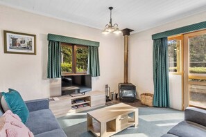 Get cosy in the living room with a fireplace to keep you warm and a central TV for your entertainment. 
