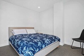 Retreat to the spacious bedroom with a comfortable queen bed, ensuring a restful night's sleep.