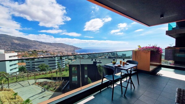 Lux Suite by LovelyStay is a luxurious apartment featuring a stunning balcony with ocean and mountain views, air conditioning, private parking, a shared pool, children’s playground, and sleek modern décor. #cityview #luxurious