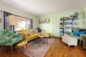 Cozy up on our comfortable sofa and enjoy the warm and inviting atmosphere of our living room