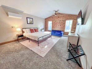 Primary bedroom (upstairs) offers a king bed, smart TV, closets, & ensuite bath.