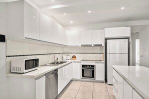 Fully equipped with a dishwasher, oven, microwave, toaster, and kettle.