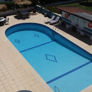 Follow the winding path through the vibrant flowers to find the sparkling pool