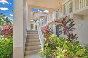 BT825 - Tropical landscaping lines the entrance to this second floor condo