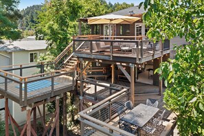 Multiple levels of decks overlook the backyard and out to the Russian River.