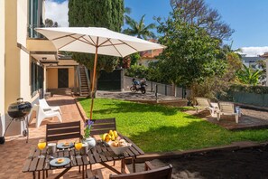 The Outdoor Dining Table And Beautiful Private Tranquil Garden At Vintage Garden Apartment In Funchal By Ourmadeira