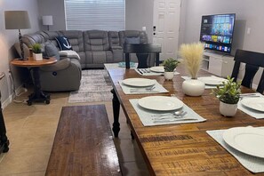Gather around the rustic dining table, set for a cozy meal with family or friends in this inviting dining space.