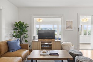 Relax in the living room and enjoy the sprawling views of the lake, or take in your favorite TV show or movie on our smart TV.