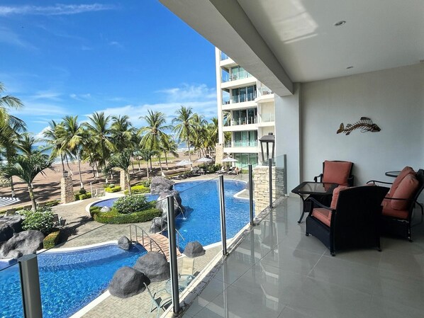 Main balcony off of living room over looking the pool and beach