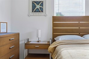 Relax in this cozy and inviting bedroom, designed for comfort with soft linens and a peaceful ambiance for a restful night’s sleep.