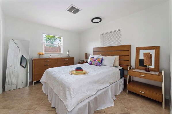 Relax in this cozy and inviting bedroom, designed for comfort with soft linens and a peaceful ambiance for a restful night’s sleep.