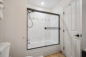 This is a full bathroom with a shower and a tub.