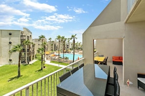 Your private balcony features tables for dining and cushioned seating