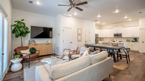 Relax in the spacious, beautifully designed living room, complete with modern furnishings and a cozy atmosphere perfect for gathering with friends and family.