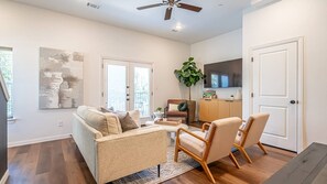 Relax in the spacious, beautifully designed living room, complete with modern furnishings and a cozy atmosphere perfect for gathering with friends and family.