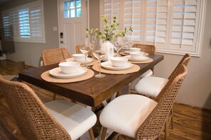 Elegant Dining Area Set for Meals: "Indulge in delightful meals in our elegantly designed dining area, where every detail is curated for a perfect dining experience."