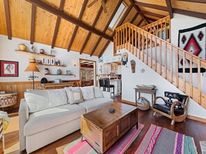 Charming cabin with cozy vibes, high ceilings, and unique decor for a warm stay.