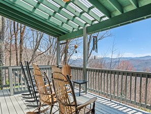 Covered deck with rocking chairs and breathtaking long-range mountain views.