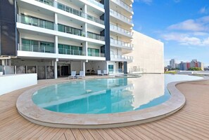 Enjoy a dip in the residents’ outdoor swimming pool with ample space to unwind.