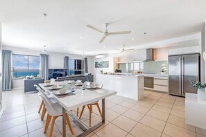 A large indoor dining table is set for six allowing guests ample space to come together for a shared meal.