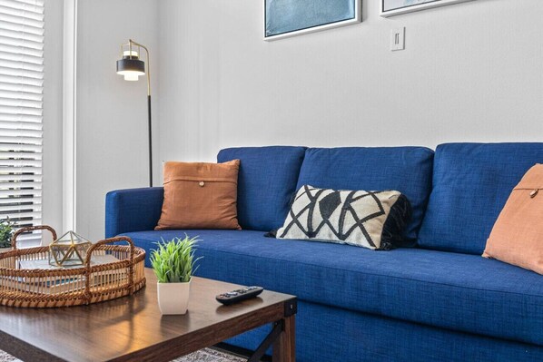 The living room’s cozy vibe makes it the perfect spot to relax, with ample seating and a warm ambiance.