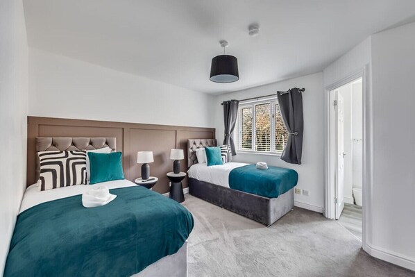 Bedroom 1 with comfortable zip link beds which is configured as two single beds by default or can be zipped together to form a king size bed upon request