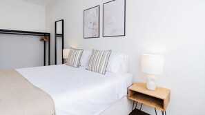 Designed for relaxation, this spacious bedroom combines minimalism with a touch of warmth, creating an inviting atmosphere with decorative accents and soft textures. #stunning #soft