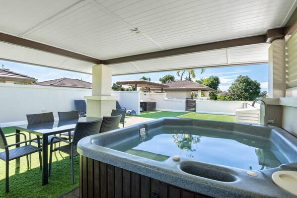 Immerse yourself in relaxation with a soothing hot tub experience, surrounded by invigorating outdoor breezes. Adjacent is a dining area for 6, perfect for shared meals.