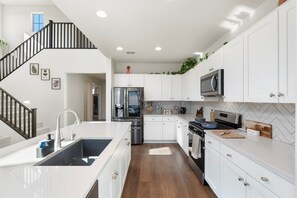 This stylish kitchen invites you to cook and gather, featuring a spacious island