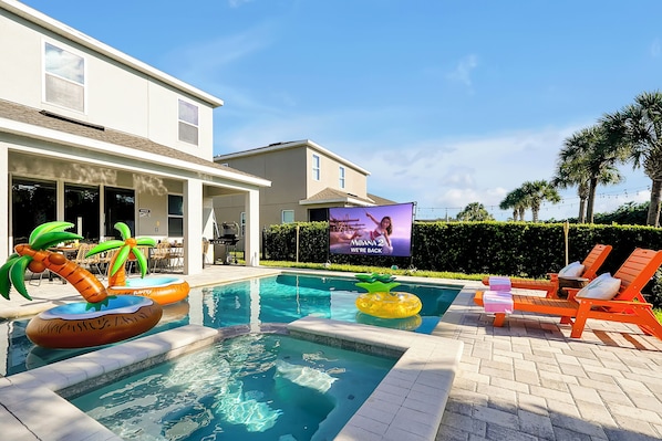 View of the pool at day with movie theater