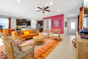 Living room with TV and board games + plush couches