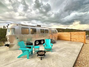 Outdoor seating area with gas fireplace at Airstream Legacy