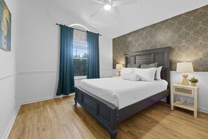 The secondary bedroom features a queen sized bed with luxurious and cozy all white linens to rest a top after a sunkissed day at the beach or exploring the town. Maximize your work from home productivity with a full sized desk