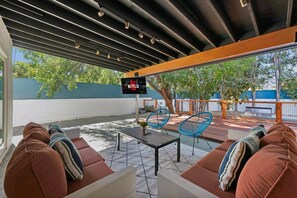 Sit under the covered outdoor patio both day or night and watch your favorite movie on the 65" TV!