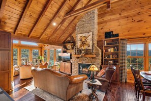Living room with gas fireplace, TV, and comfy seating.