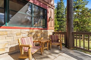 Spacious private balcony with outdoor seating and gas grill.