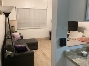 View of the living room from the kitchen showing a surge protector.