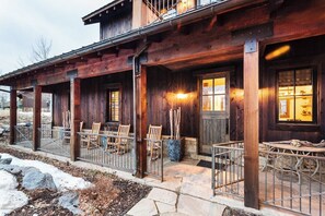 Cozy Front Porch – A welcoming glow, rustic beams, and stylish seating make this the perfect spot to unwind.